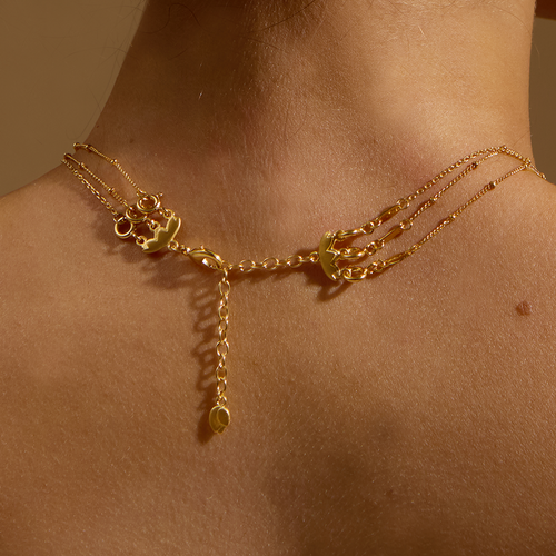 Close-up of the 3-Necklace Layering Extension Chain worn on a model's neck, showcasing its beautiful gold finish. This spiritual jewelry piece enhances your necklace layers while representing values like meaning and zodiac signs, perfect for those who practice meditation or seek inspiration.