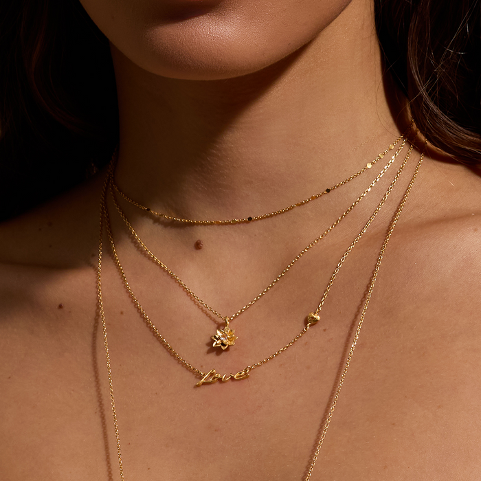 Layered look featuring the Adorned with Love Gold Necklace alongside other delicate pieces. This necklace represents individuality and creativity, making it perfect for spiritual practices such as yoga and meditation.