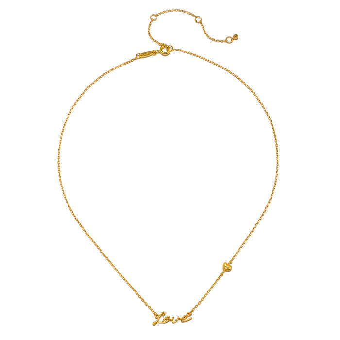 Close-up of the Adorned with Love Gold Necklace featuring the word 'Love' in elegant script, representing spirituality and individuality. A meaningful piece of jewelry that serves as a talisman for protection and manifestation during yoga and meditation.