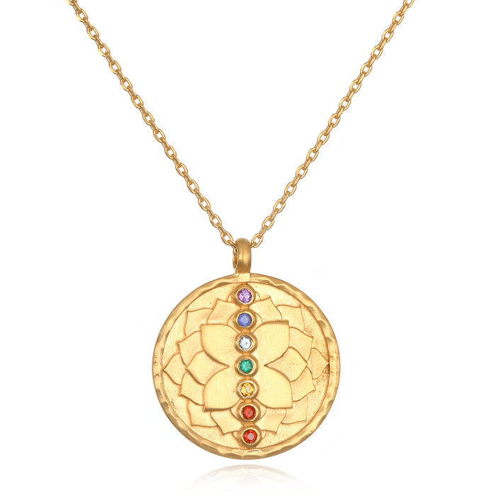 Aligned in Purpose Chakra Necklace featuring a golden pendant engraved with lotus petals and seven semi-precious gemstones, symbolizing spiritual jewelry and meditation gifts. This meaningful and symbolic piece is perfect for those seeking protection and manifestation in their yoga practice, connecting to sacred energies and zodiac beliefs.