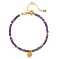Amethyst Lotus February Birthstone Bracelet featuring faceted round amethyst beads and an 18k gold plated lotus flower pendant, symbolizing spirituality and new beginnings. This piece of spiritual jewelry is perfect for meditation and manifestation, ideal for yoga practitioners seeking a meaningful talisman for protection and peace of mind.