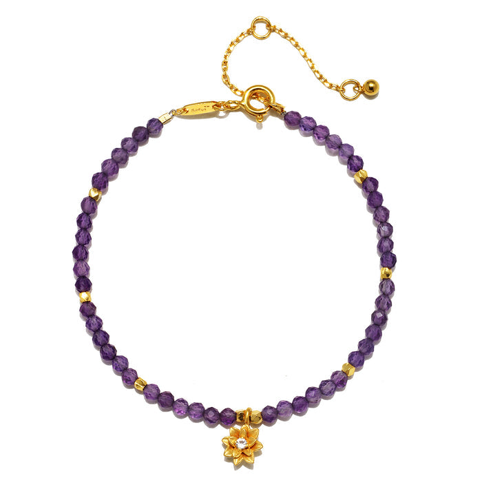 Amethyst Lotus February Birthstone Bracelet featuring faceted round amethyst beads and an 18k gold plated lotus flower pendant, symbolizing spirituality and new beginnings. This piece of spiritual jewelry is perfect for meditation and manifestation, ideal for yoga practitioners seeking a meaningful talisman for protection and peace of mind.