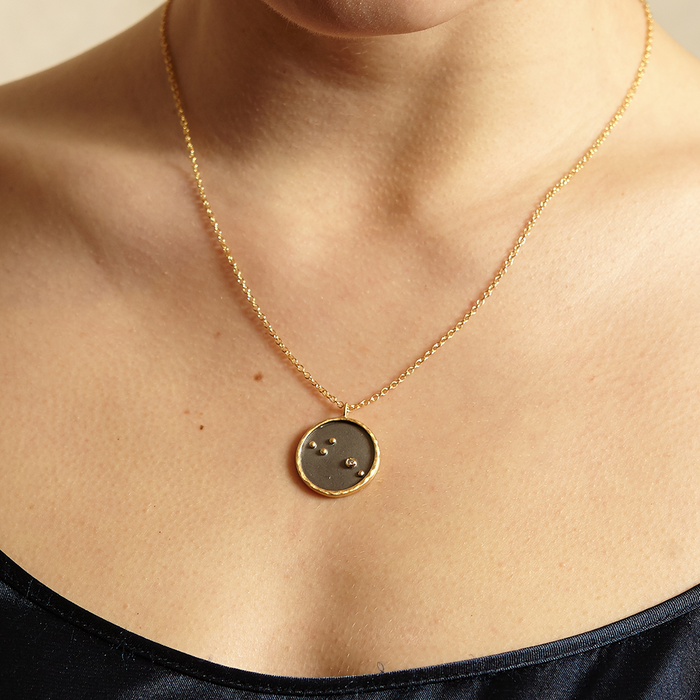 Close-up of the Aries Zodiac Necklace worn by a model, showcasing its intricate details and stunning craftsmanship. This symbolic piece of spiritual jewelry is designed for those who embrace their zodiac strengths, making it an excellent choice for meaningful mantra practices and meditation. A sacred amulet representing the vibrant energy of Aries, this necklace is perfect for yoga enthusiasts.