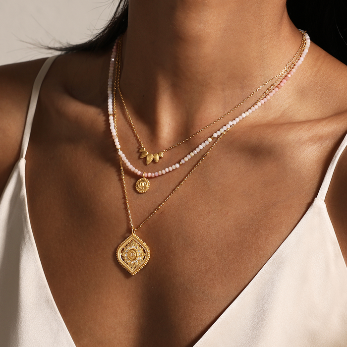 A model wearing the Beauty of Transformation Lotus Petal Necklace layered with additional spiritual jewelry, showcasing its delicate lotus petal design symbolizing new beginnings and manifestation. Perfect for yoga and meditation enthusiasts seeking meaningful adornments.
