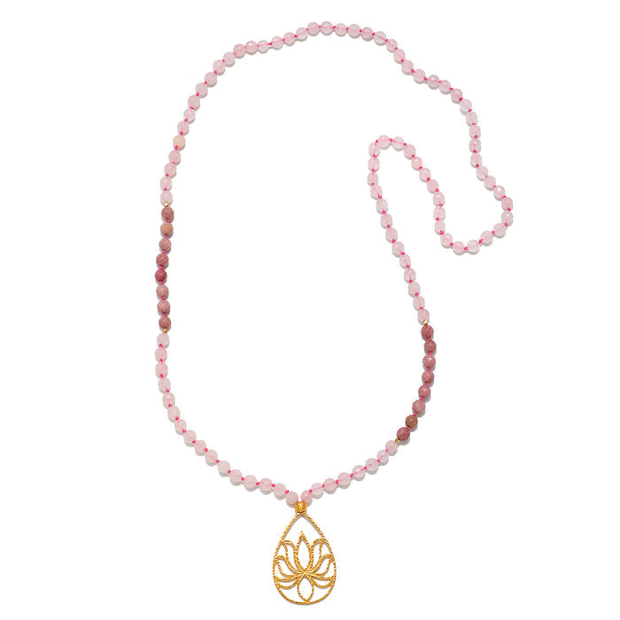 The Bloom In Love Rose Quartz Lotus Mala features 108 hand-beaded rose quartz beads, symbolizing unconditional love and compassion. Anchored by a gold-plated lotus flower, this spiritual jewelry piece serves as a beautiful talisman for meditation and manifestation practices. Perfect for yoga enthusiasts and those seeking spiritual protection, this mala embodies meaning and charm.