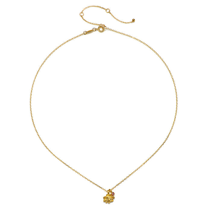 Close-up of the Bloom in Peace Lotus & Tourmaline Necklace, displaying the 18kt gold plate lotus pendant accented by a pink tourmaline gemstone. This piece of spiritual jewelry is perfect for those seeking balance and meaning in their meditation and manifestation practices.
