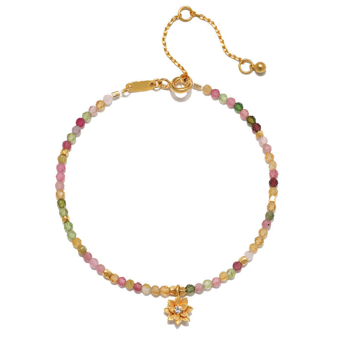 Bloom On Your Path Pink Tourmaline Lotus Bracelet showcasing a delicate lotus pendant with pink tourmaline and topaz beads, symbolizing new beginnings and transformation. This piece of spiritual jewelry is perfect for meditation and is a meaningful talisman for those practicing yoga and manifestation while embracing the energy of the sun and moon.