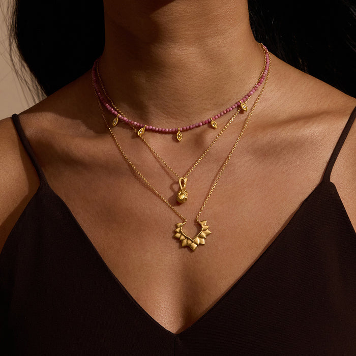 A woman showcasing the Blooming Love Lotus Petal Necklace layered with other accessories, exemplifying the essence of spiritual jewelry and meditation. This elegant necklace symbolizes transformation and renewal, perfect for those on a journey of personal growth and manifestation.