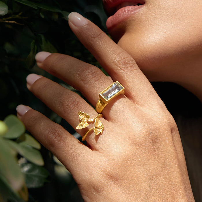 Close-up of the Blooming Splendor Lotus Green Amethyst Ring adorned alongside a butterfly ring, representing the beauty of spiritual jewelry. This combination invokes feelings of tranquility and empowerment, perfect for sun and moon rituals and manifestation.
