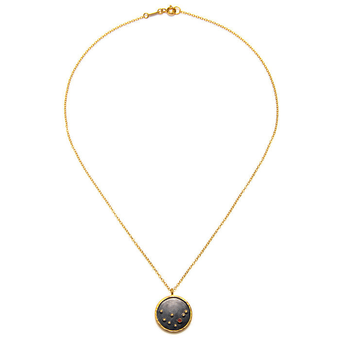 The Capricorn Zodiac Necklace laid flat, emphasizing the intricate detailing of the pendant along with its gold finish. This meaningful piece merges spirituality with style, making it perfect for yoga and manifestation.