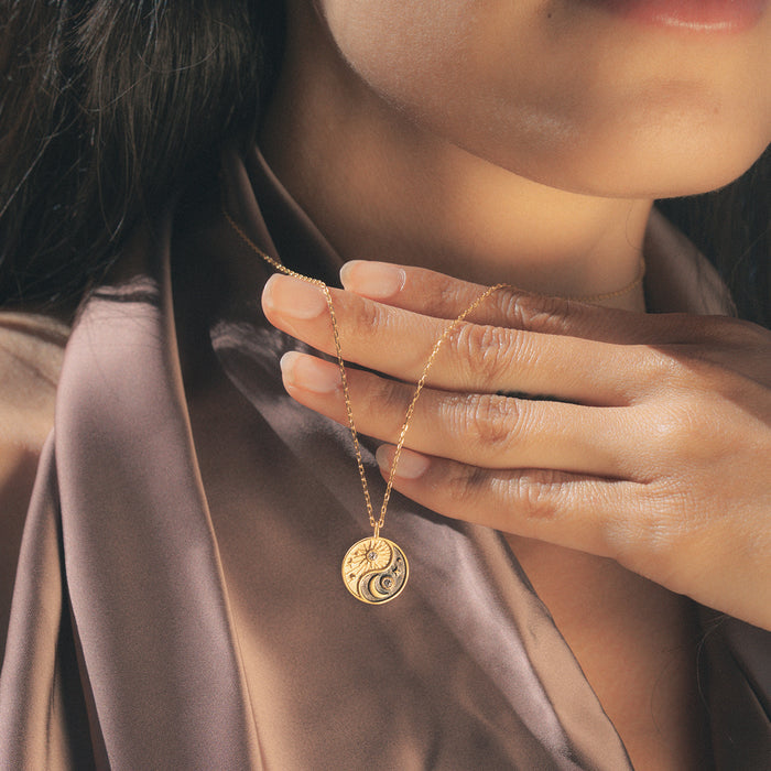 Close-up of the Celestial Balance Yin Yang White Topaz Necklace, highlighting its intricate sun and moon details. A perfect talisman for those seeking spiritual connection, manifestation, and the balance of energies in their life.