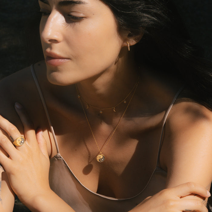 A close-up of the Celestial Balance Yin Yang White Topaz Ring worn by a woman, emphasizing its elegant design. This piece of spiritual jewelry reflects the rich symbolism of zodiac and protection, making it a perfect accessory for meditation and meaningful practices.