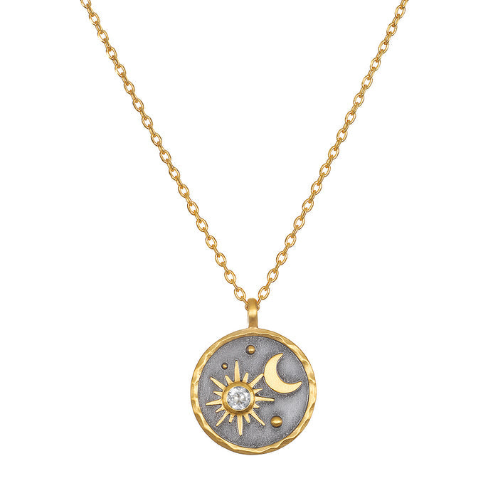 Celestial Birthstone Necklace - April featuring a stunning sun and moon design in 18kt gold plate against a gunmetal background. This spiritual jewelry piece symbolizes individuality and creativity, perfect for meditation and manifestation. Ideal for yoga enthusiasts seeking meaningful talismans for protection and spiritual growth.