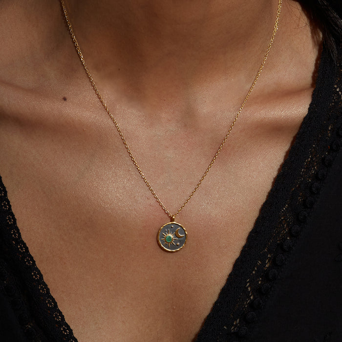 Close-up of the Celestial Birthstone Necklace - May worn by a model, showcasing the emerald accent and sun-moon design, ideal for yoga and spiritual meaning in your jewelry collection.