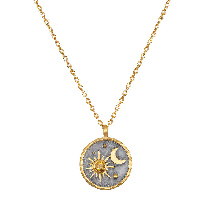 Celestial Birthstone Necklace - November featuring a radiant sun and crescent moon design set in 18kt gold plate against a gunmetal background. This stunning piece of spiritual jewelry serves as a meaningful talisman for meditation and manifestation, aligning with zodiac energies. Perfect for yoga enthusiasts seeking protection and inspiration from celestial symbols.