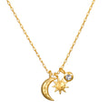 Gold-toned necklace with chain featuring moon, sun, and crystal pendant charms.