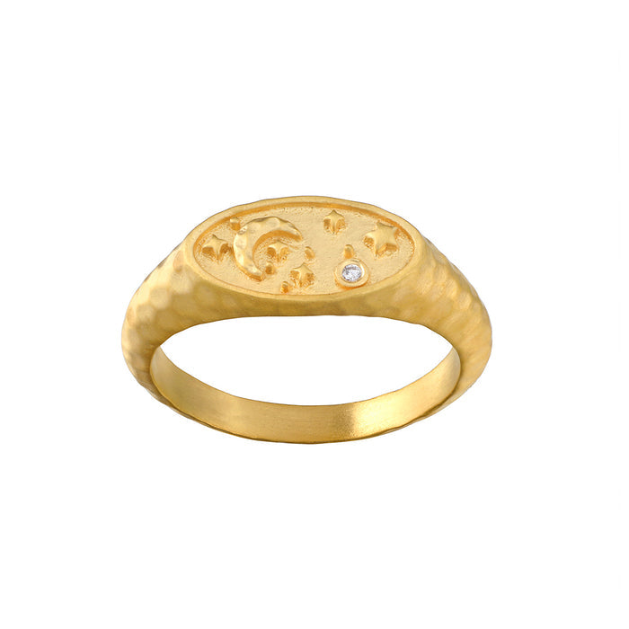 Gold signet ring with celestial engravings on oval face and small diamond accent.