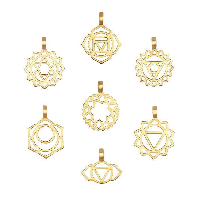 Seven gold-toned metal charms with geometric chakra symbols and lotus petal designs arranged in a circular pattern.