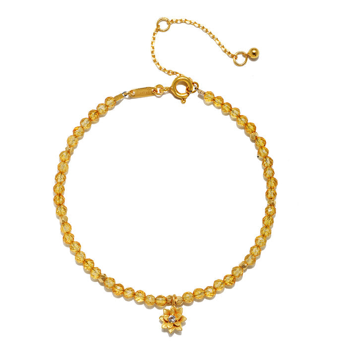 Citrine Lotus November Birthstone Bracelet featuring a delicate 18kt gold plated lotus flower pendant, representing new beginnings. This spiritual jewelry combines elements of meditation and manifestation with its radiant citrine stones, making it a meaningful talisman for those born in November. Ideal for yoga enthusiasts seeking protection and positivity, this bracelet embodies the essence of the sun and moon.