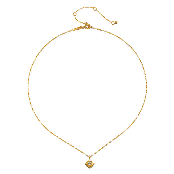 The Clarity White Topaz Starburst Necklace displayed elegantly against a neutral background, representing a meaningful piece of spiritual jewelry that inspires clarity, protection, and connection to the sun and moon.