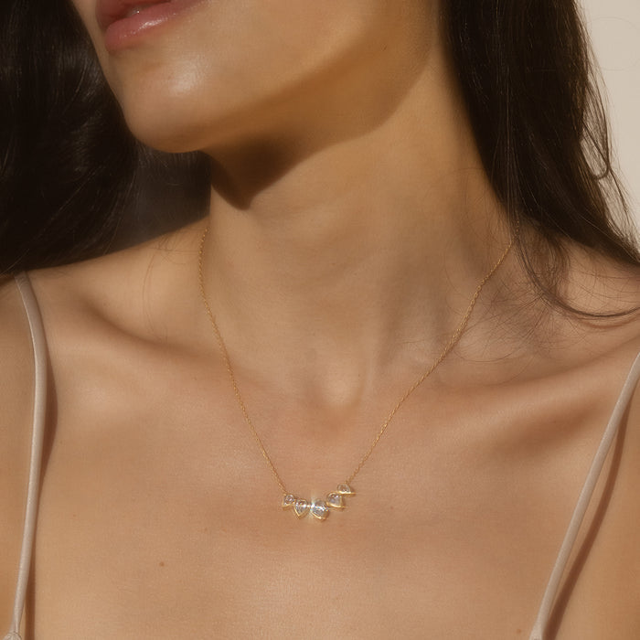 A model wearing the Commence with Clarity White Topaz Lotus Petal Necklace, embodying spiritual jewelry and representing new beginnings, meditation, and clarity. This meaningful piece serves as a talisman for transformation, connecting to the themes of manifestation and protection, perfect for yoga enthusiasts.