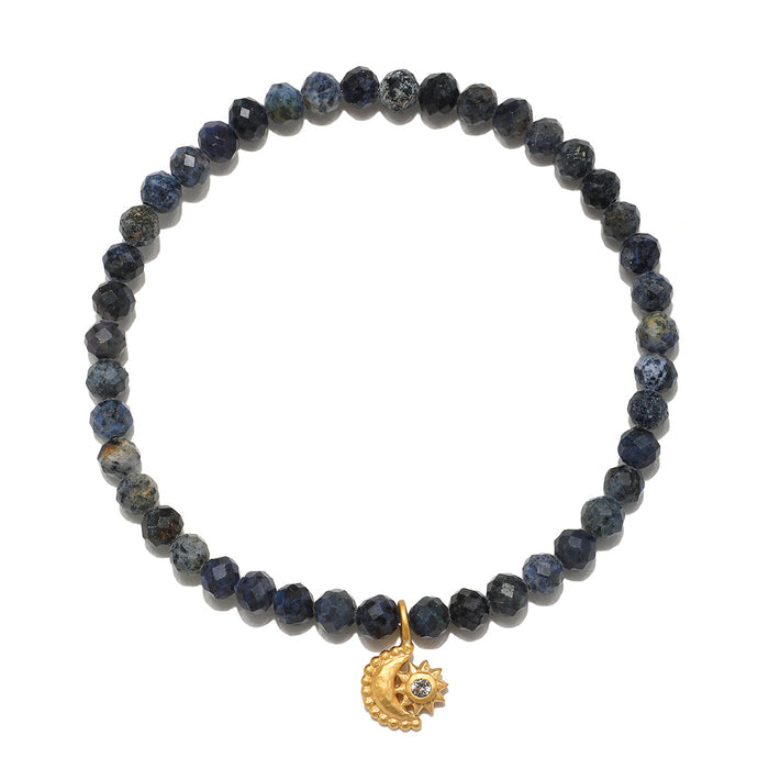 Stretch bracelet with dark blue and black faceted beads and a gold moon and sun charm pendant.