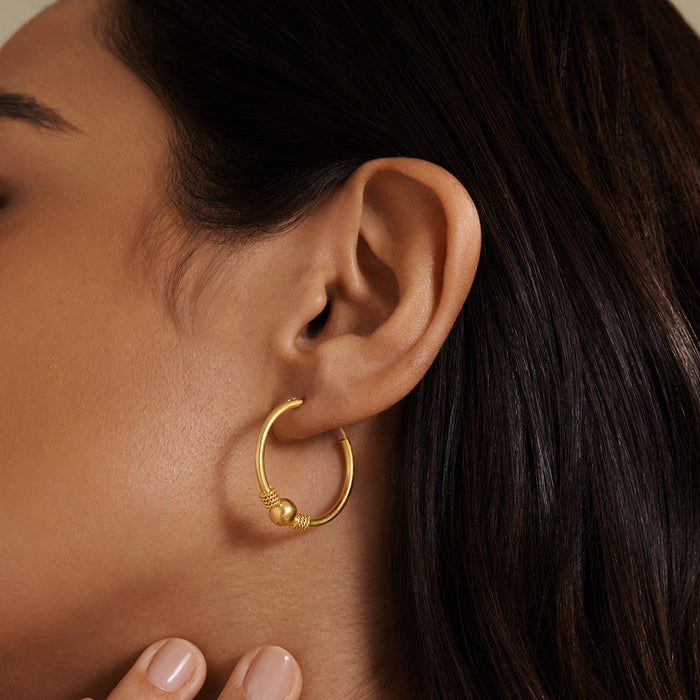Close-up of the Courageous Spirit Earrings showcasing their 18kt gold plated design, featuring a bold bead and delicate rope detail. These earrings are perfect for those seeking spiritual jewelry for meditation and manifestation, embodying protection and meaningful connections to the sun and moon.