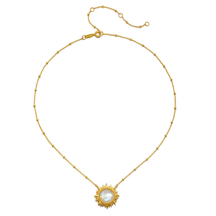 Gold-tone chain necklace with beaded links and a sun-shaped pendant featuring a white moonstone center.
