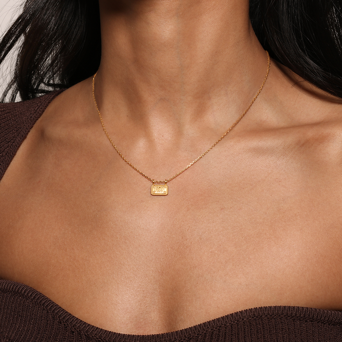 Close-up of the Dawn of Renewal Lotus Necklace worn by a model, showcasing its elegance with the engraved lotus flower pendant. This spiritual necklace embodies the essence of new beginnings and charm, ideal for those seeking inspiration and positivity in their daily life.