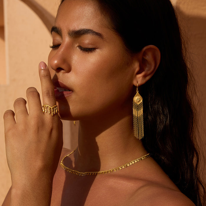 Gold fringe drop earrings with opal details hanging from ear wires.