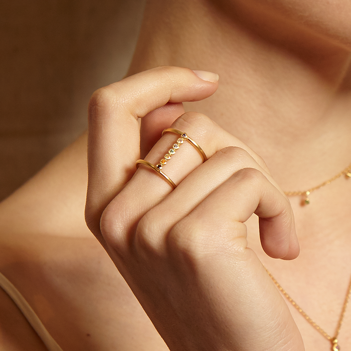 A close-up of the Divine Alignment Chakra Adjustable Ring worn on a hand, showcasing the gleaming stones that reflect the 7 chakras, perfect for spiritual jewelry, meditation gifts, and embodying meaningful symbolism for manifestation.