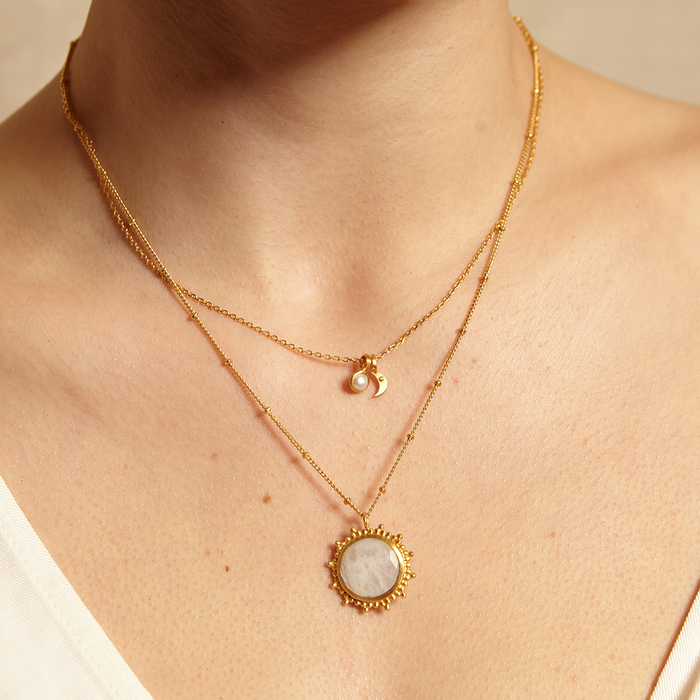 Close-up of the Drift Into Daydreams Moonstone Gemstone Necklace on a model's neck, highlighting its moonstone pendant, symbolizing inner peace and good fortune in spiritual practices like meditation.