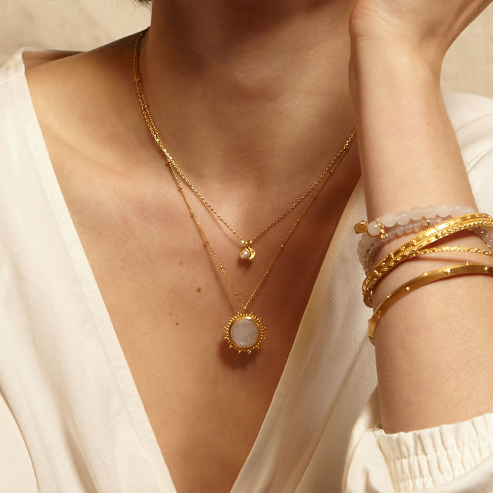 The Drift Into Daydreams Moonstone Gemstone Necklace displayed alongside other jewelry, emphasizing its role as a talisman for protection and manifestation in daily life.