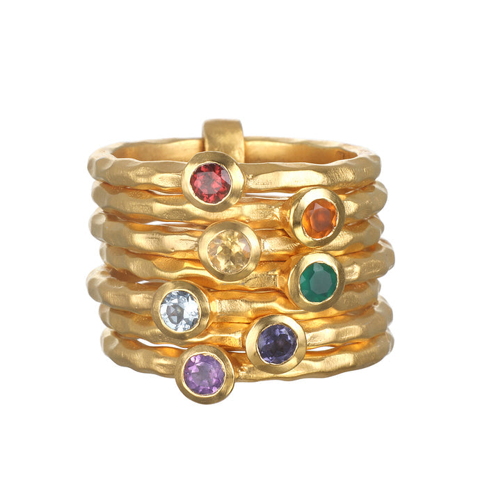 Ebb and Flow Chakra Stacked Statement Ring showcasing seven gold-plated rings adorned with various gemstones. This spiritual jewelry serves as a talisman for meditation, embodying the energy of the chakras for protection and meaningful manifestation in your yoga practice.