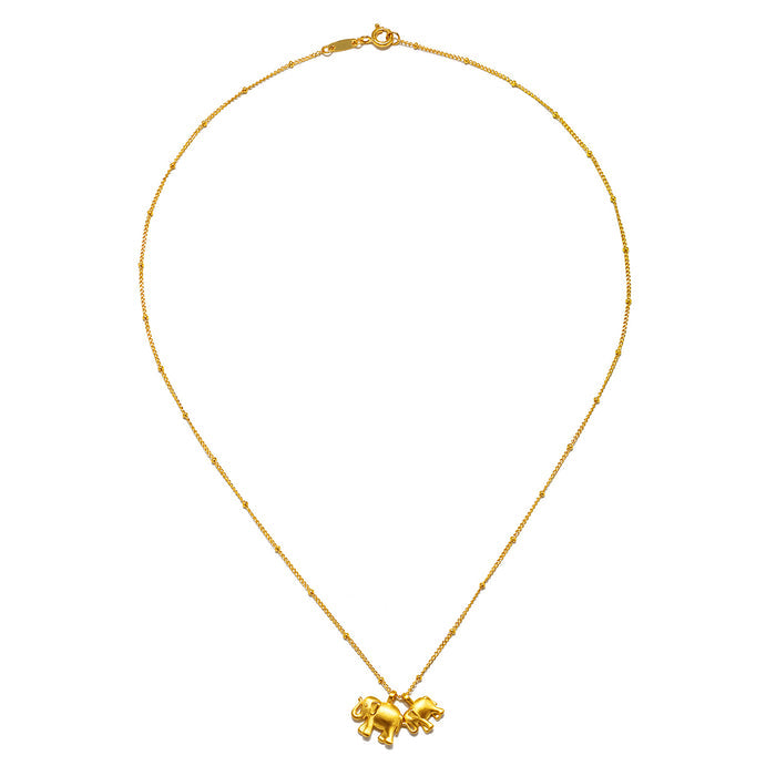 The Elephant Love Gold Necklace featuring two intricately designed elephants, embodying meaningful attributes and ideal for yoga practice, enhancing your spiritual journey as a talisman of good fortune.