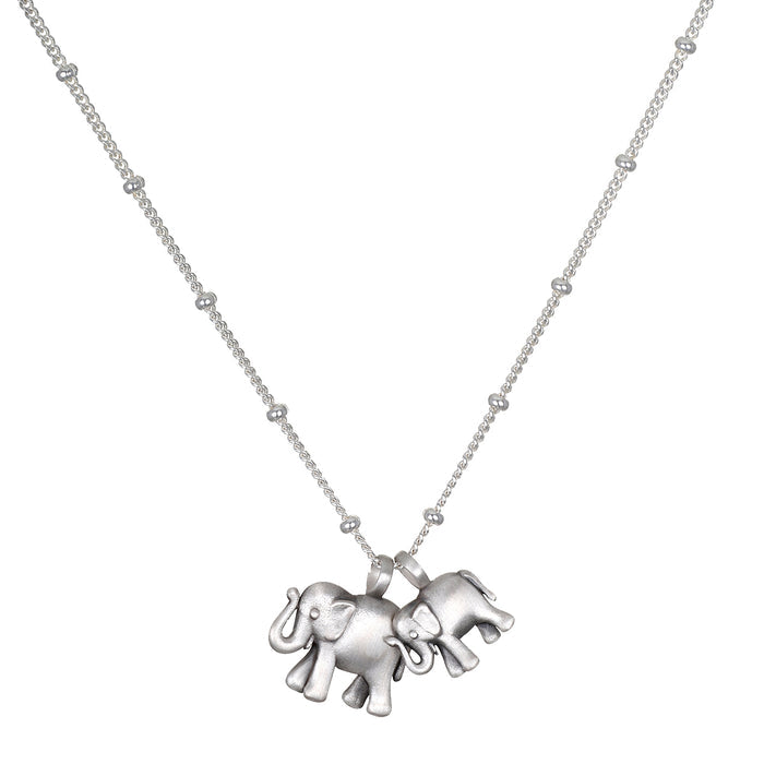 Elephant Love Silver Necklace featuring two intricately designed sterling silver elephants on a delicate chain, symbolizing strength, wisdom, and good fortune. This spiritual jewelry is perfect for meditation and serves as a meaningful talisman. Ideal for yoga practitioners and those interested in manifestations of charm and protection.