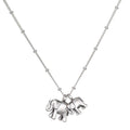 Elephant Love Silver Necklace featuring two intricately designed sterling silver elephants on a delicate chain, symbolizing strength, wisdom, and good fortune. This spiritual jewelry is perfect for meditation and serves as a meaningful talisman. Ideal for yoga practitioners and those interested in manifestations of charm and protection.