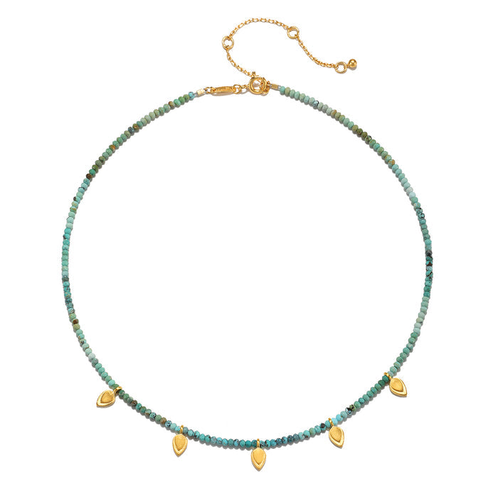 Emerging Hope Turquoise Petal Choker Necklace featuring turquoise beads and golden lotus petals, symbolizing new beginnings and full potential. This piece of spiritual jewelry is perfect for meditation and manifestation, embodying protection and meaningful charm. Ideal for yoga enthusiasts and zodiac lovers.