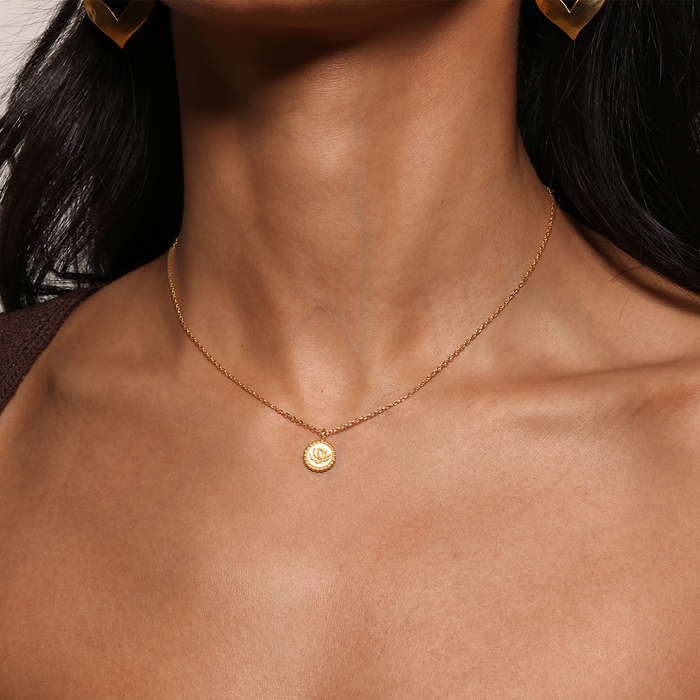Close-up of a woman wearing the Emerging Potential Lotus Necklace, showcasing its elegant design as a meaningful accessory. Perfect for yoga enthusiasts and those involved in spiritual practices, this necklace embodies the essence of protection and transformation.