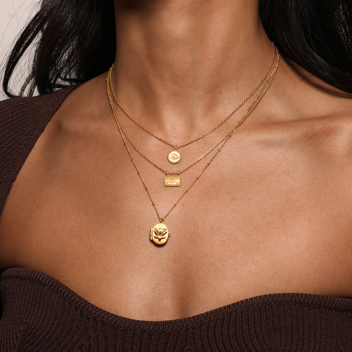 Layered view of the Emerging Potential Lotus Necklace alongside other delicate gold necklaces, creating a stylish and spiritual jewelry look. This combination emphasizes the beauty of meaningful talismans and charms suitable for meditation and manifestation.