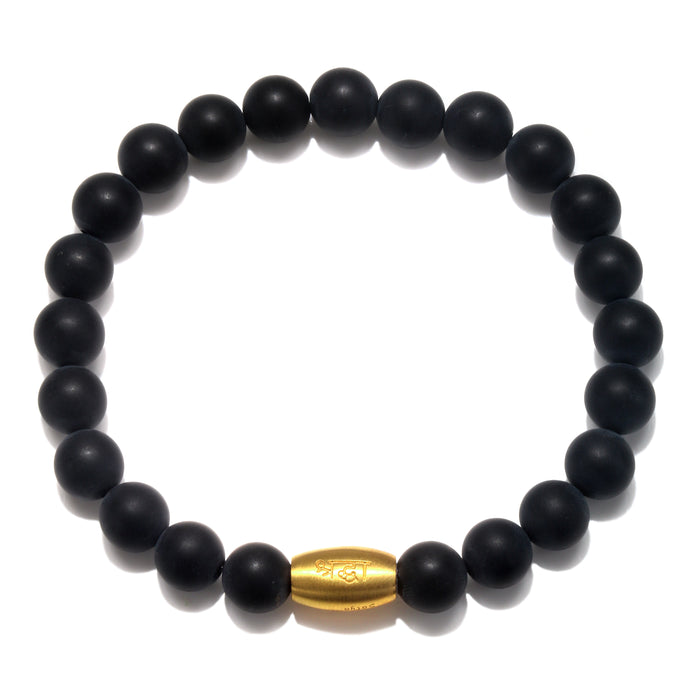 Enduring Faith Black Onyx Mens Stretch Bracelet featuring matte black onyx beads that symbolize endurance and perseverance, complemented by a gold gunmetal bead. Ideal as spiritual jewelry for meditation gifts, this meaningful and protective bracelet serves as a sacred amulet for yoga practice and manifestation.