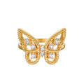 Gold butterfly ring with white topaz stones set in center and beaded edges on wings.