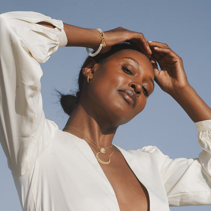Eternal Guidance Moon Necklace styled on a model in a serene outdoor setting, emphasizing its spiritual qualities as a meaningful accessory. This necklace represents the moon's protective energy and is perfect for meditation, yoga, and manifesting dreams.