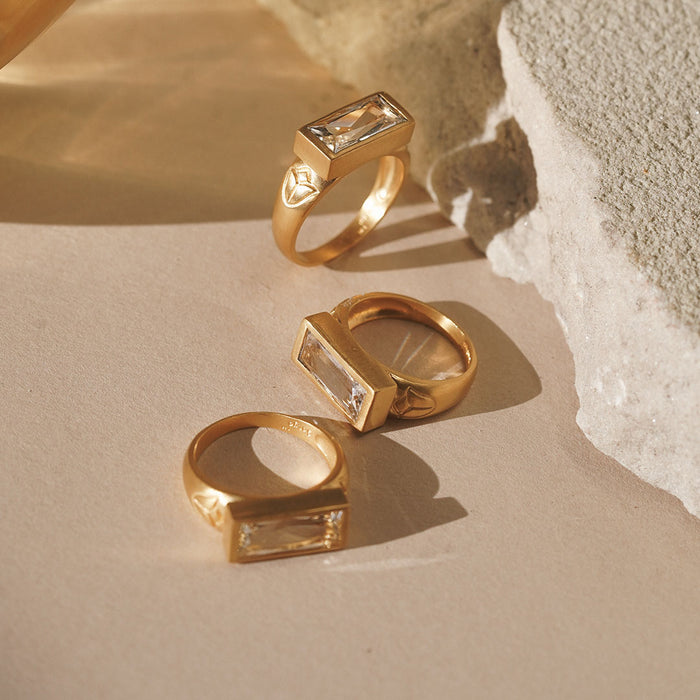 A beautifully arranged display of multiple Eternal Radiance White Topaz Rings, showcasing their elegant design and brilliant facets. This collection represents meaningful talismans suitable for yoga practices and zodiac connections, enhancing spirituality, protection, and new beginnings in your life.