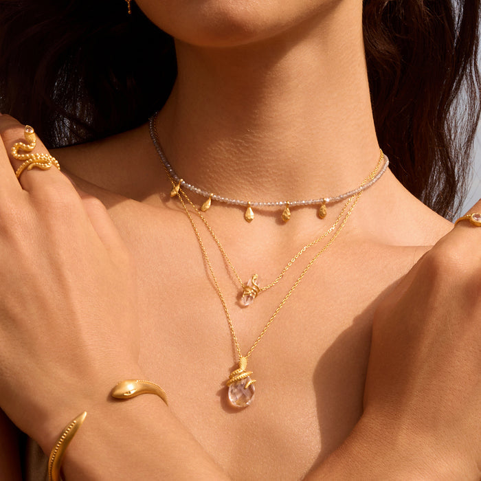 Eternal Spirit Clear Quartz Snake Necklace showcased on a model's neck, layered with other spiritual jewelry, radiating meaningful energy for meditation and protection, perfect for yoga and manifestation practices.