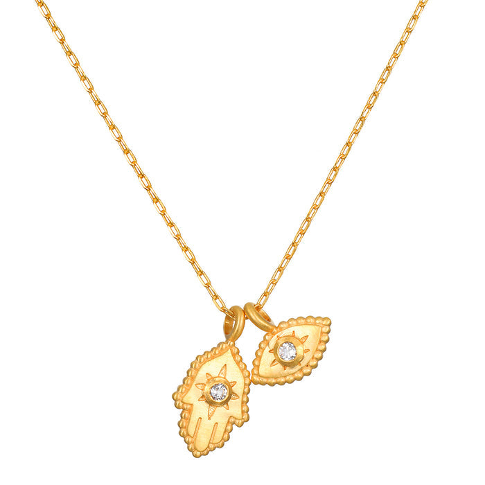 Gold-toned chain necklace with two hamsa hand pendants featuring crystal centers.