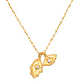 Gold-toned chain necklace with two hamsa hand pendants featuring crystal centers.