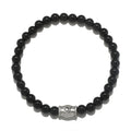 Extended Journey Men's Black Onyx Bracelet featuring a silver 'om' charm, representing spiritual jewelry that enhances meditation and serves as a meaningful talisman. This bracelet is perfect for those seeking protection and harmony in their yoga practice and aligns with the energies of the sun and moon, making it a beautiful manifestation charm.