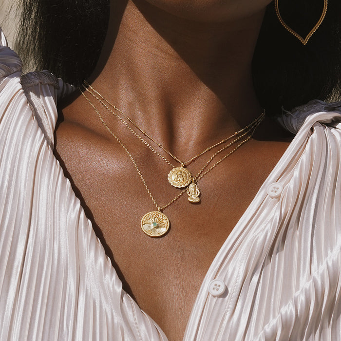 The Favored by Fortune Ganesha Necklace worn alongside other layers, highlighting the spiritual jewelry's elegance and its connection to meditation, talisman, and meaningful manifestation.