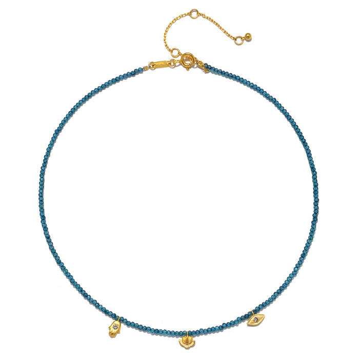 Blue topaz beaded necklace with gold-tone charms and adjustable chain clasp.